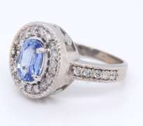 Powerful 18kt oval Sapphire and Diamond Halo Ring