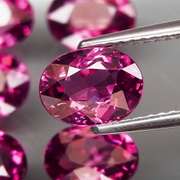 Excellent 8.81ct oval cut violet red Garnet set