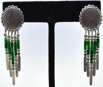 Silver Earrings With Green Beads Dangling From Them