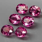 Excellent 8.81ct oval cut violet red Garnet set