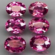 Excellent 8.81ct oval cut violet red Garnet set
