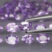 Heavy flashing 5.47ct oval cut Tanzanite set