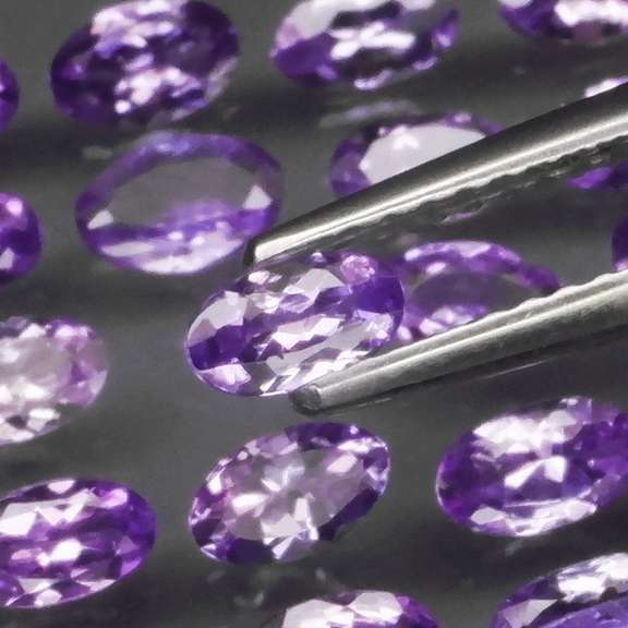 Heavy flashing 5.05ct oval cut Tanzanite set