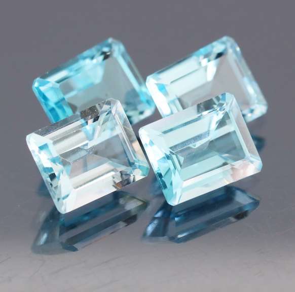 Big 16.07ct vivid blue emerald cut Topaz set