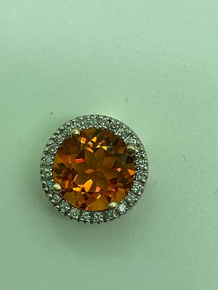 14K GOLD DIAMOND AND TOPAZ PENDANT.