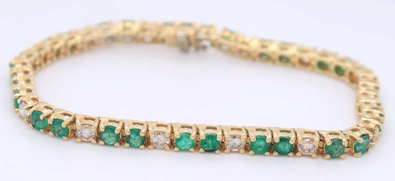 Sepctacular Yellow Gold Emerald and Diamond Tennis Bracelet