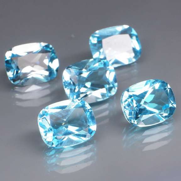 Large 16.95ct vivid blue cushion cut Topaz set
