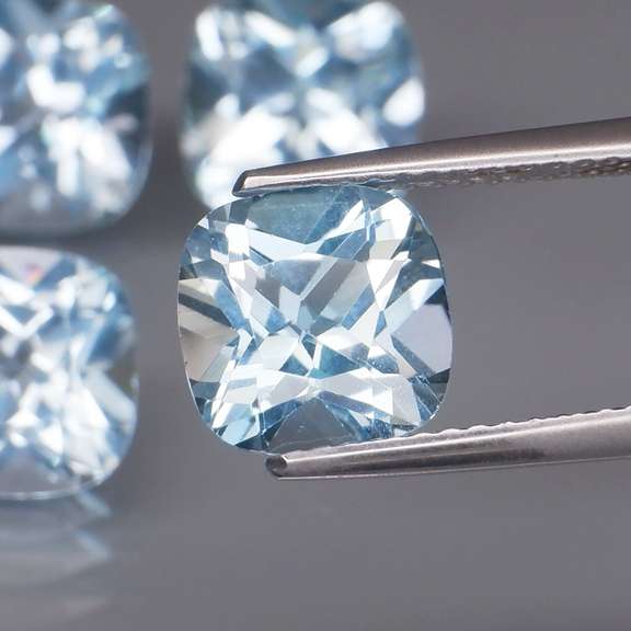 Stunning 10.69ct vivid blue cushion cut Topaz set