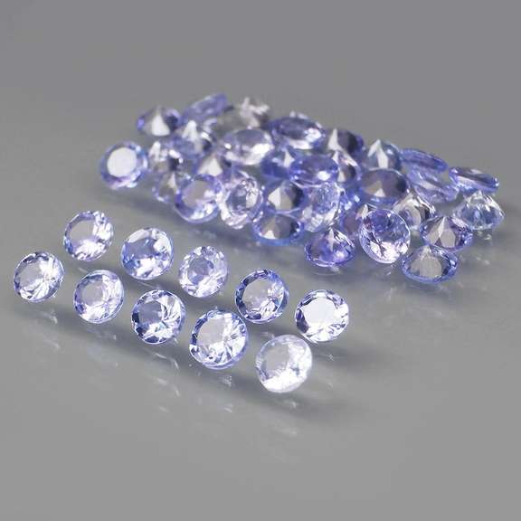 Heavy flashing 4.81ct round Tanzanite set