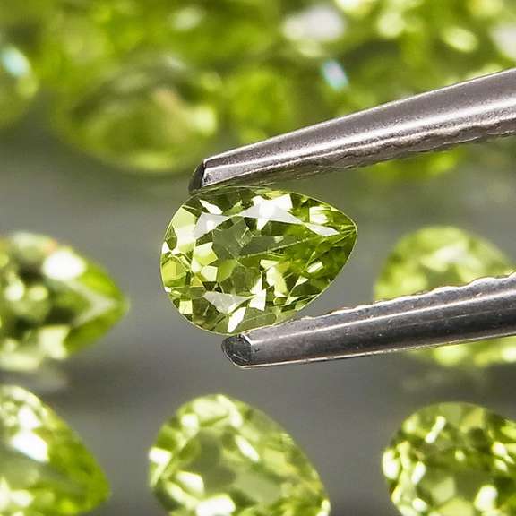 Dazzling 8.22ct untreated apple green pear shaped Peridot set