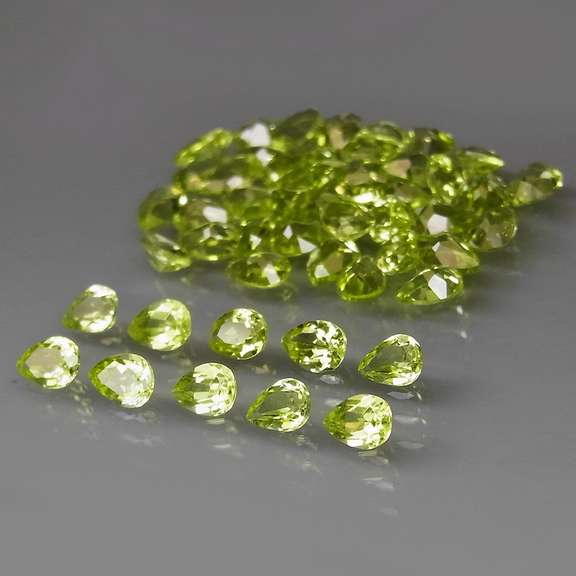 Dazzling 8.22ct untreated apple green pear shaped Peridot set