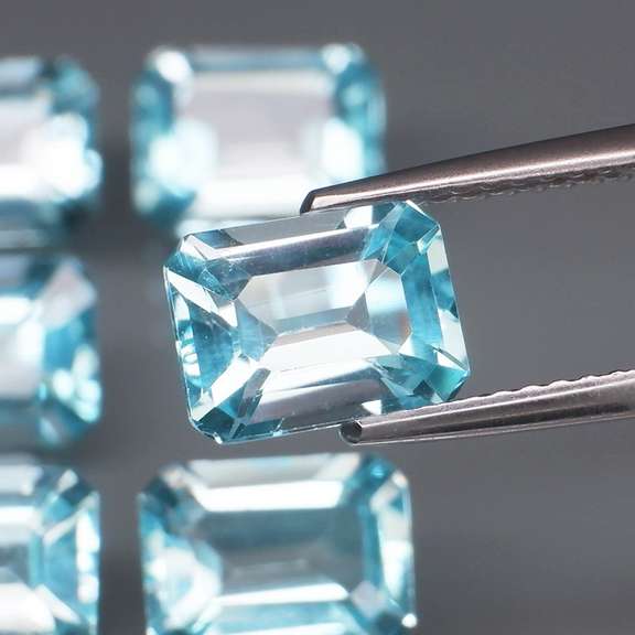 Large 11.31ct vivid blue emerald cut Topaz set