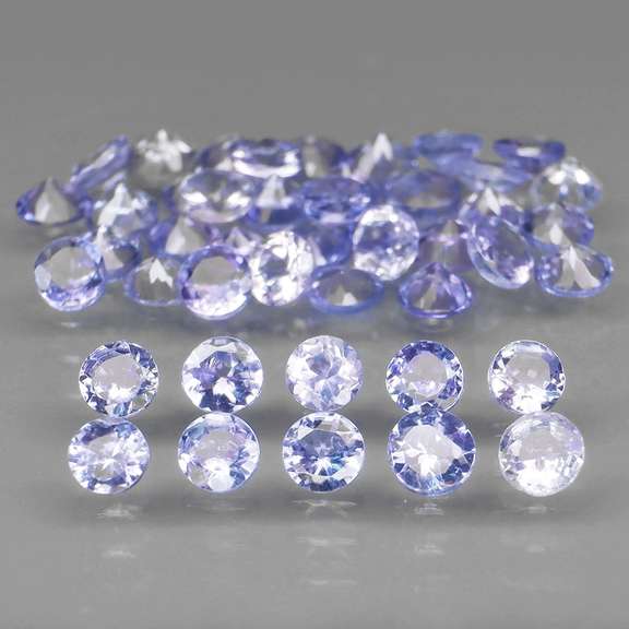 Heavy flashing 4.81ct round Tanzanite set