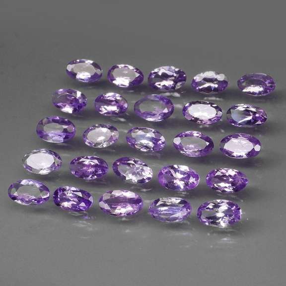 Heavy flashing 5.05ct oval cut Tanzanite set