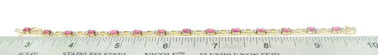 LADIES RUBIES AND DIAMOND GOLD BRACELET.