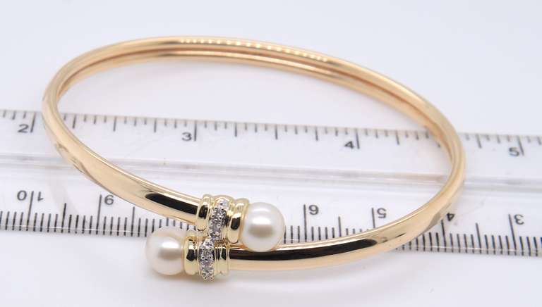 Elegant Yellow Gold Pearl and Diamond Bypass Bracelet