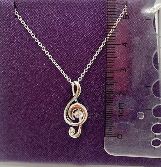 solid sterling silver and dancing simulated diamond musical note pendant