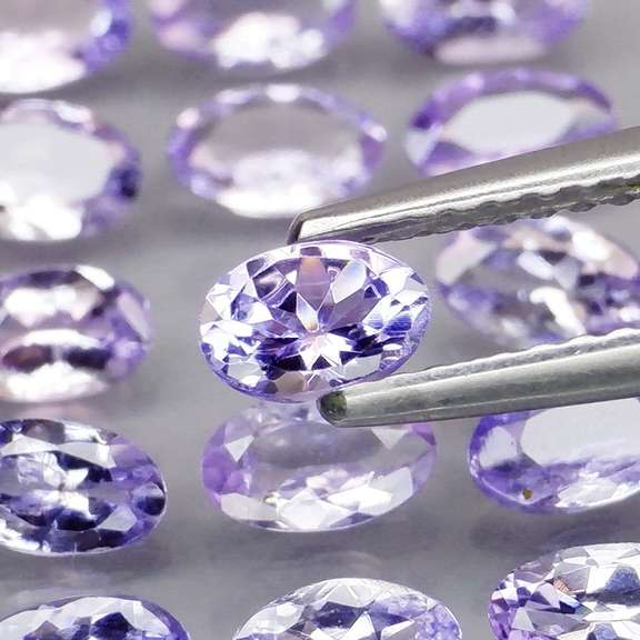 Heavy flashing 3.87ct oval cut Tanzanite set