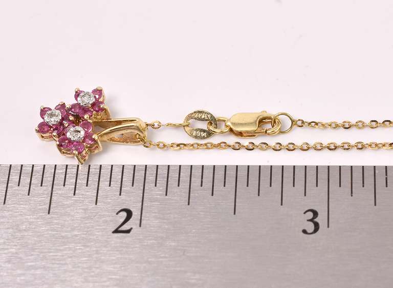 Sensational Ruby and Diamond Flower Pendant in 14K Yellow Gold