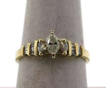 Oval Diamond Ring beset by Baguette Diamonds on a 14k Gold Band