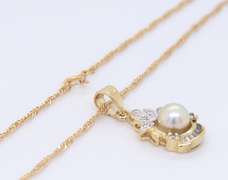 Delightful Yellow Gold Pearl and Round and Baguette Diamond pendant on Chain