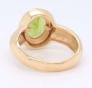 Attractive Yellow Gold oval Peridot Bezel Set Ring