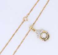 Delightful Yellow Gold Pearl and Round and Baguette Diamond pendant on Chain
