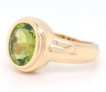 Attractive Yellow Gold oval Peridot Bezel Set Ring