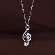solid sterling silver and dancing simulated diamond musical note pendant