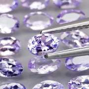 Heavy flashing 3.87ct oval cut Tanzanite set
