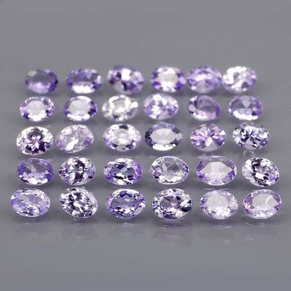 Heavy flashing 4.98ct oval cut Tanzanite set