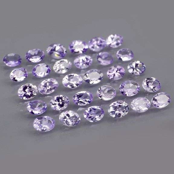 Heavy flashing 4.98ct oval cut Tanzanite set
