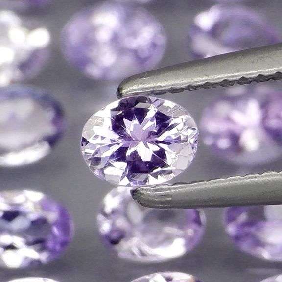 Heavy flashing 4.98ct oval cut Tanzanite set