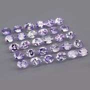 Heavy flashing 4.98ct oval cut Tanzanite set