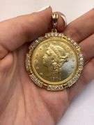 1904 GOLD COIN FRAMED IN 14K YELLOW GOLD AND ROUND BRILLIANT DIAMONDS