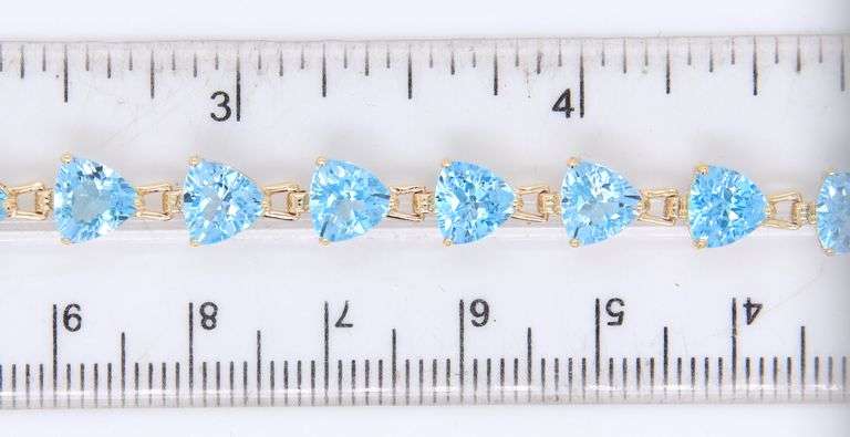 14kt Yellow gold heart shaped blue topaz tennis bracelet