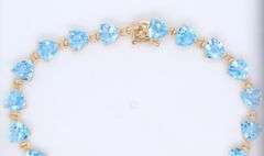 14kt Yellow gold heart shaped blue topaz tennis bracelet