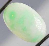 Uncommon 26.45ct light green Jadeite Jade cabochon