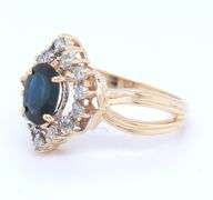 14kt Yellow gold oval blue sapphire and diamond halo marquise shaped ring