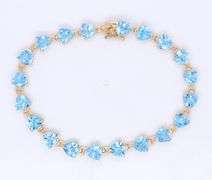 14kt Yellow gold heart shaped blue topaz tennis bracelet