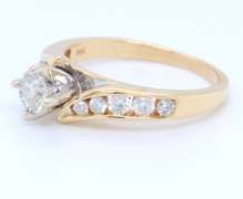 Elegant Round Brilliant Cut and Channel Set Diamond Engagement Ring in Yellow Gold