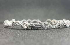 STUNNING 3.50 CARATS T.W. ROUND PAVÉ SET LEO TENNIS BRACELET IN 18K WHITE GOLD