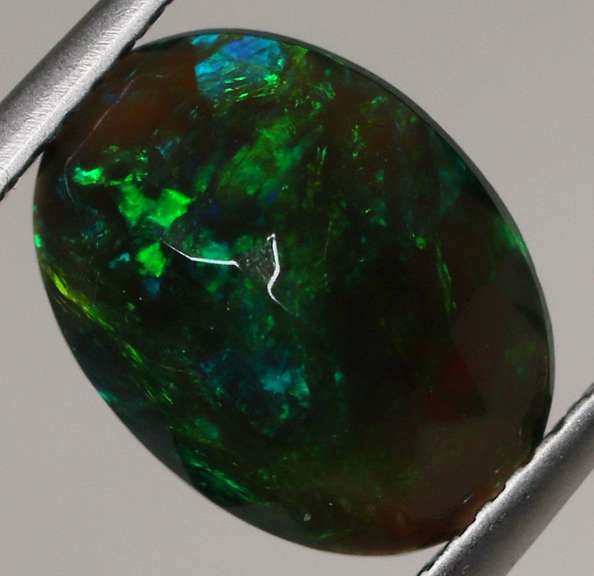 Smoldering flashing 1.85ct black Opal