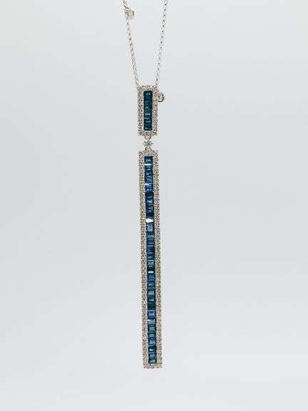 Tantilizing 18kt White Gold Necklace With Elongated Diamond and Saphire Pendant