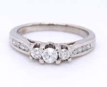 Attractive White Gold Three Stone Channel Set Diamond Shank Engagement Ring