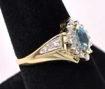 Elegant Blue Topaz And Diamond Ring In 14K Yellow Gold