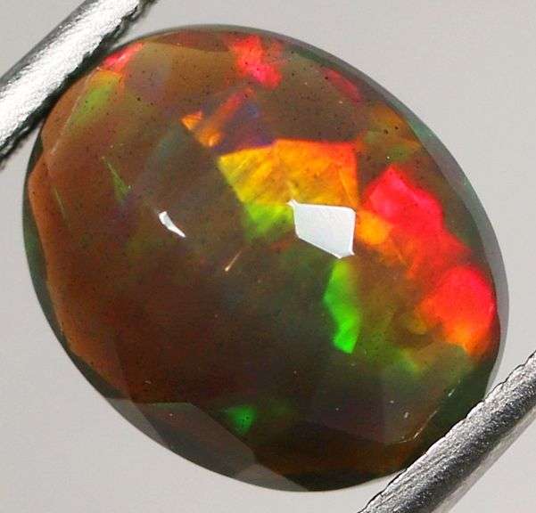 Fully faceted full panel flashing 1.64ct oval cut Black Opal