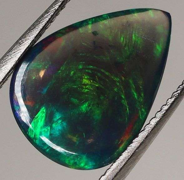 Silky black with blue and green flashing 1.34ct Black Opal cabochon