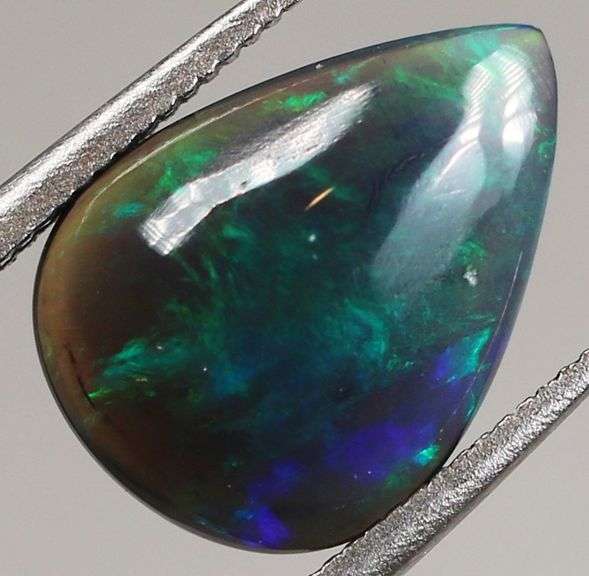 Silky black with blue and green flashing 1.34ct Black Opal cabochon