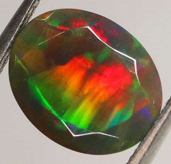 Fully faceted full panel flashing 1.64ct oval cut Black Opal
